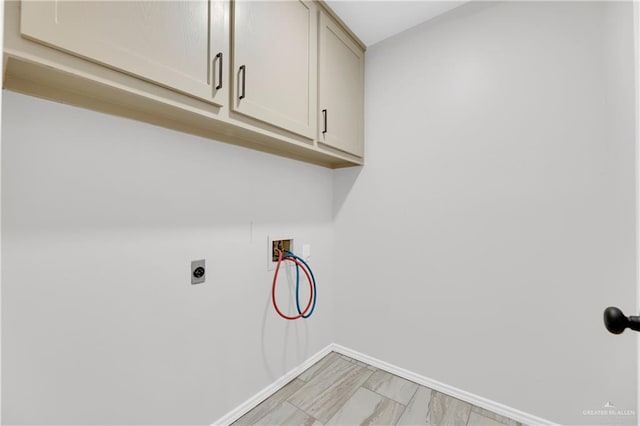 laundry area with cabinets, hookup for a washing machine, and hookup for an electric dryer