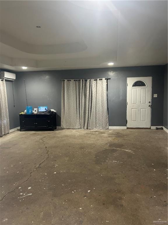 interior space with concrete flooring and a wall mounted AC