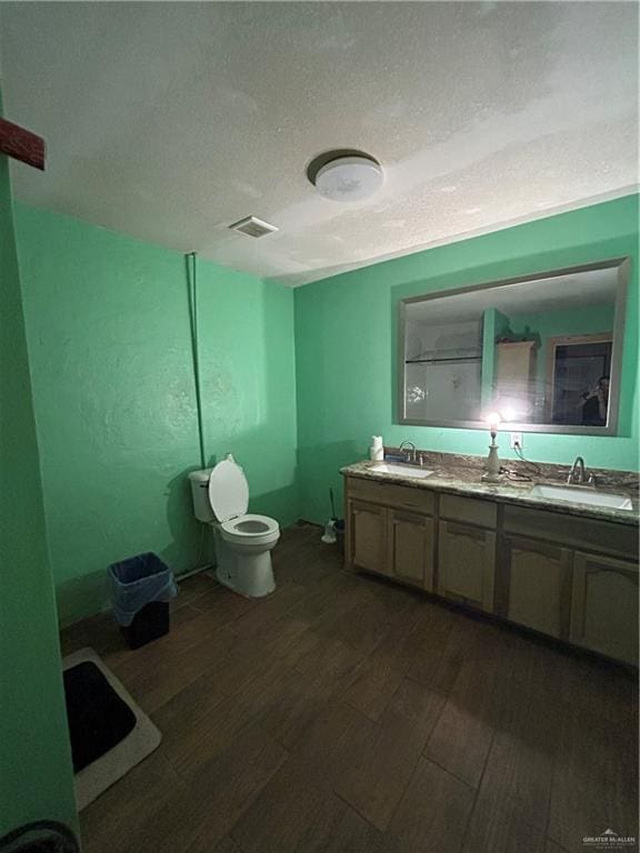 bathroom featuring vanity, a textured ceiling, and hardwood / wood-style flooring