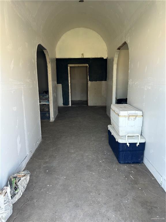 hall featuring vaulted ceiling