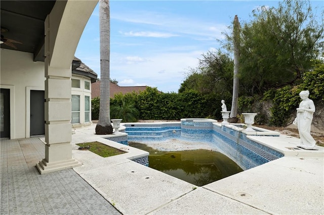 view of swimming pool with an in ground hot tub and a patio