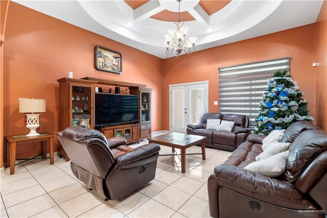 living room featuring light tile patterned floors, french doors, a tray ceiling, and a chandelier