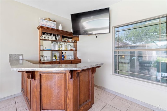 bar featuring light tile patterned floors