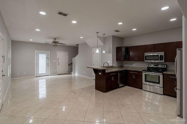 kitchen with sink, ceiling fan, light tile patterned floors, appliances with stainless steel finishes, and decorative light fixtures