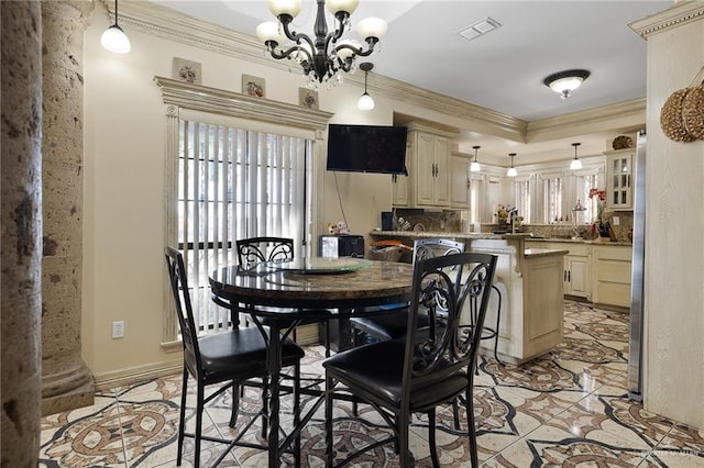 dining room with ornamental molding and a notable chandelier