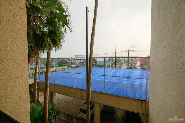 view of tennis court with fence