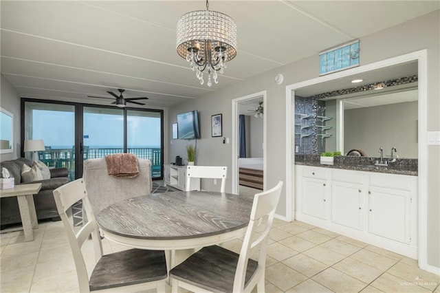 dining space featuring ceiling fan, light tile patterned flooring, and a chandelier