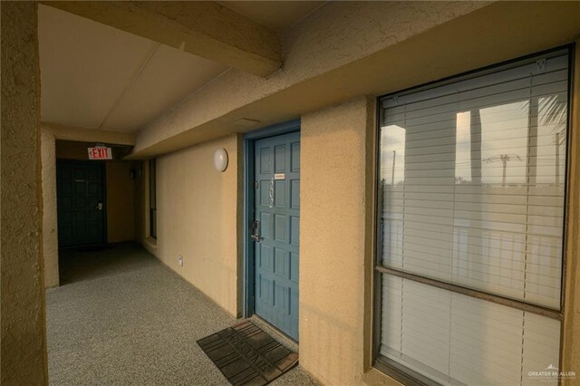 entrance to property with stucco siding