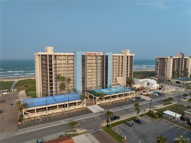 3000 Gulf Blvd Unit 302, South Padre Island, TX 78597 - view of building exterior with a water view and uncovered parking