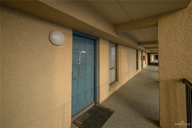 view of exterior entry featuring stucco siding