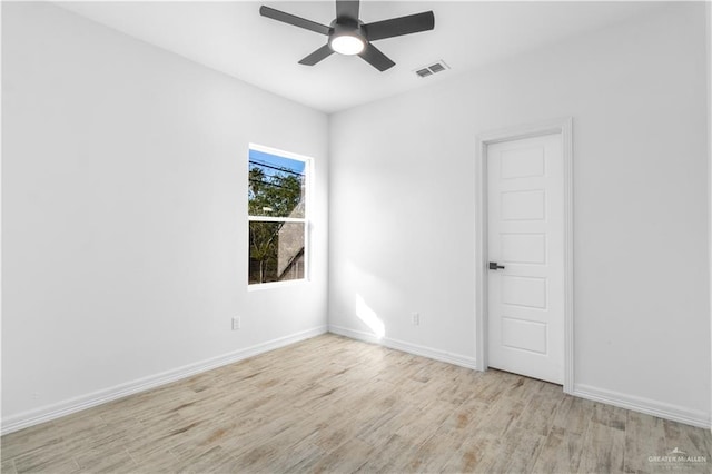 empty room with ceiling fan and light hardwood / wood-style flooring