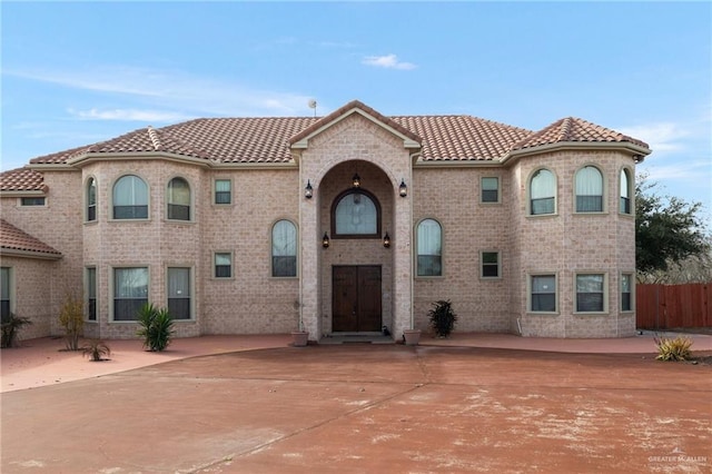 mediterranean / spanish-style home with a patio