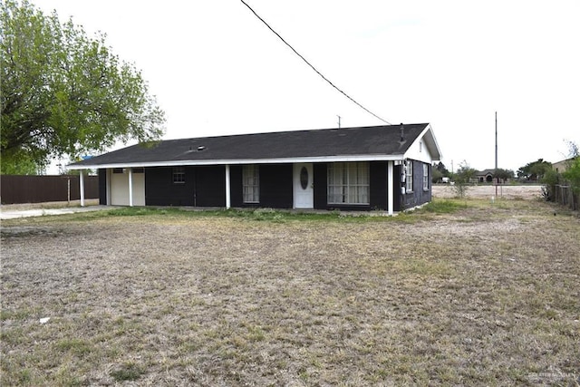 view of front of house featuring an attached garage and fence