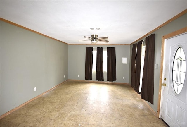 entrance foyer with visible vents, baseboards, a ceiling fan, and ornamental molding