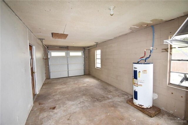 garage with concrete block wall and electric water heater