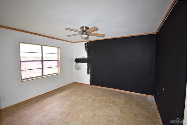 spare room featuring crown molding, a ceiling fan, baseboards, and tile patterned floors