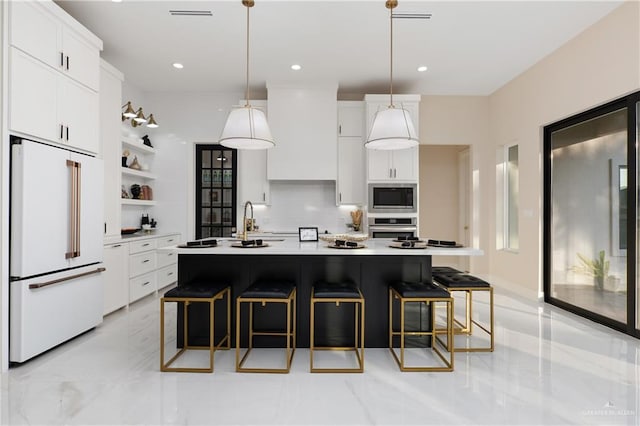 kitchen featuring white cabinetry, a kitchen island with sink, hanging light fixtures, and appliances with stainless steel finishes