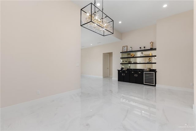 living room featuring wine cooler and a chandelier