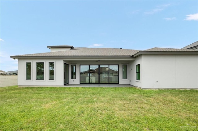 rear view of property featuring a lawn and a patio area