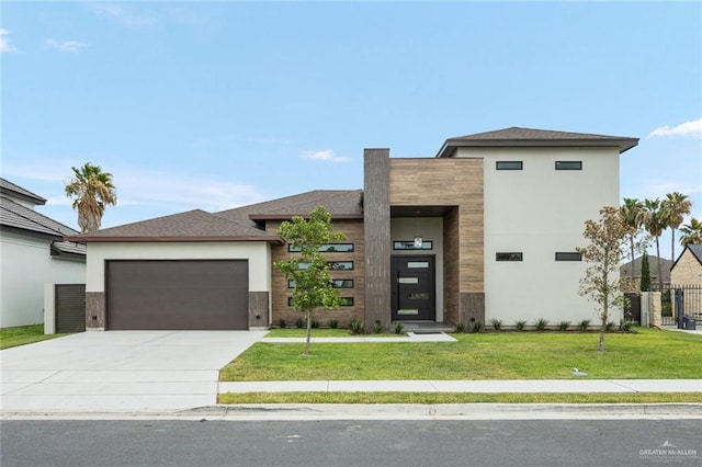 view of front of house with a front yard and a garage