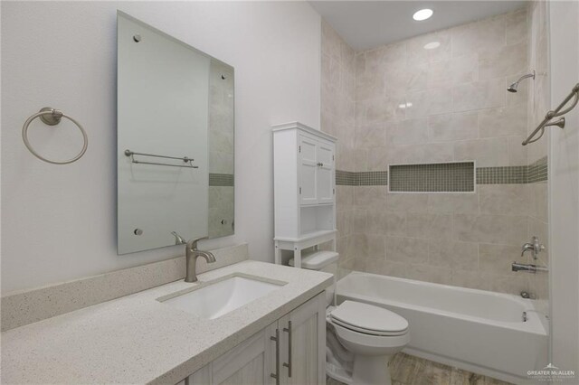 full bathroom featuring bathtub / shower combination, toilet, vanity, and wood finished floors