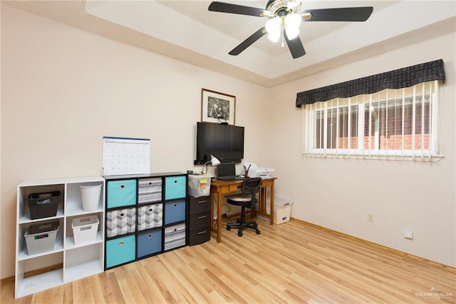 office space featuring wood finished floors and ceiling fan