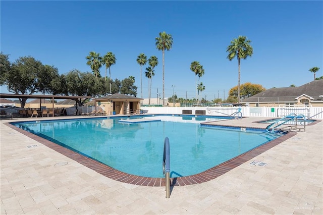 pool with fence and a patio
