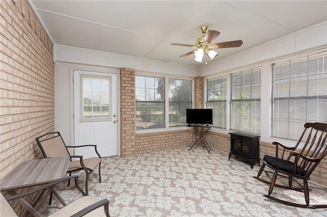 sunroom featuring a wood stove