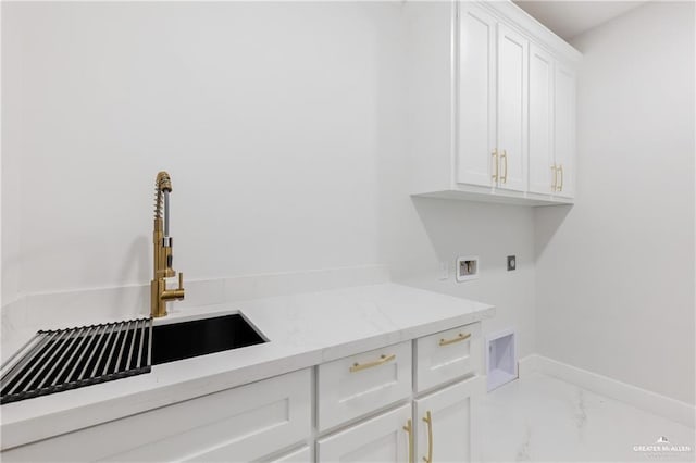 laundry room with cabinets, sink, and washer hookup