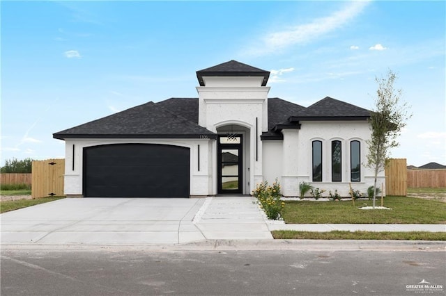 view of front of home featuring a garage and a front lawn