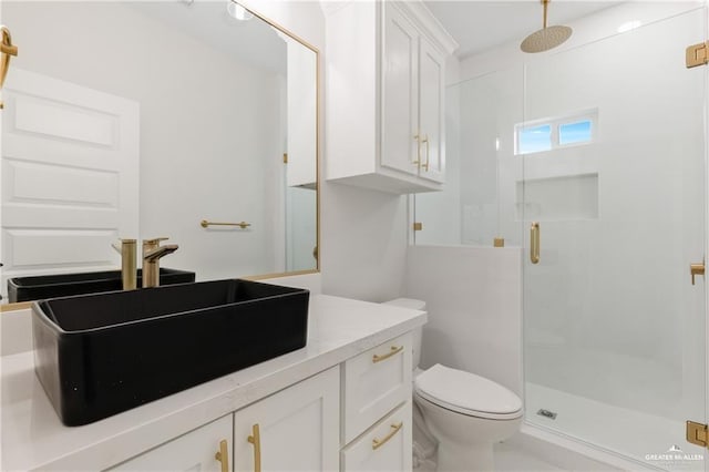 bathroom featuring vanity, toilet, and an enclosed shower