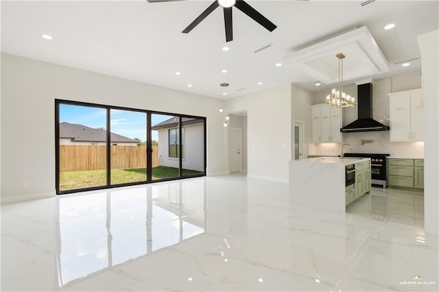 interior space featuring hanging light fixtures, wall oven, light stone countertops, white cabinets, and wall chimney exhaust hood