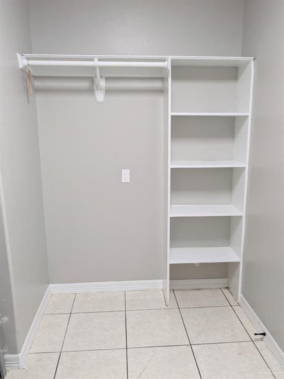 spacious closet with tile patterned floors