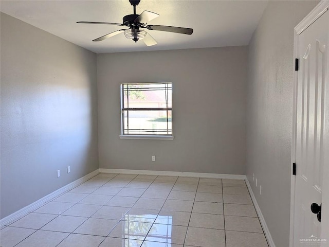 tiled empty room featuring ceiling fan