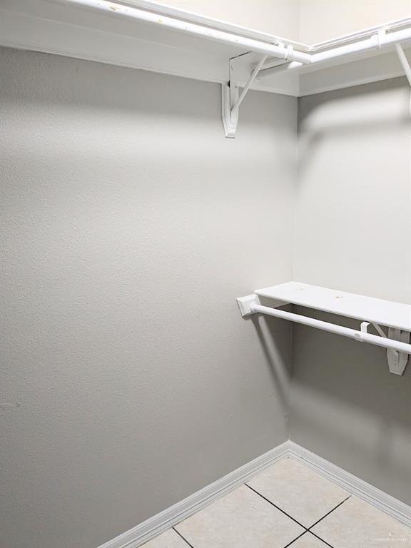 spacious closet with tile patterned floors