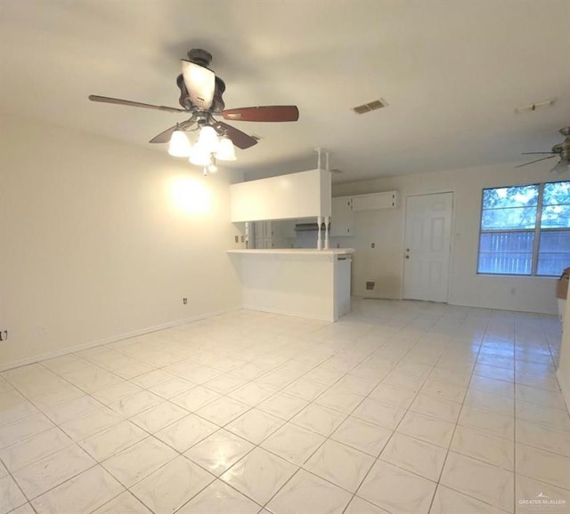 unfurnished living room featuring ceiling fan and light tile patterned flooring