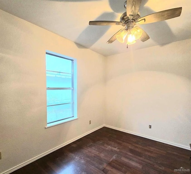 spare room featuring ceiling fan and dark wood-type flooring