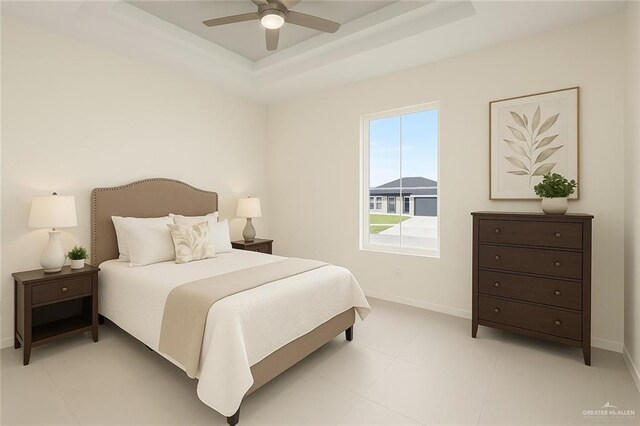 2012 Trinity St, Donna, TX 78537 - bedroom featuring baseboards, a tray ceiling, and ceiling fan