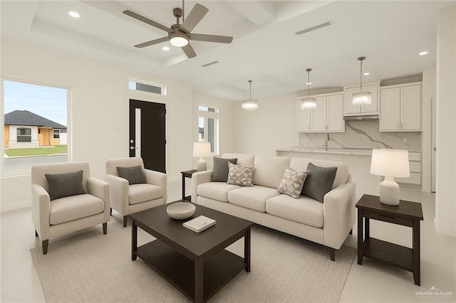 2012 Trinity St, Donna, TX 78537 - living room with visible vents, recessed lighting, a ceiling fan, a tray ceiling, and baseboards