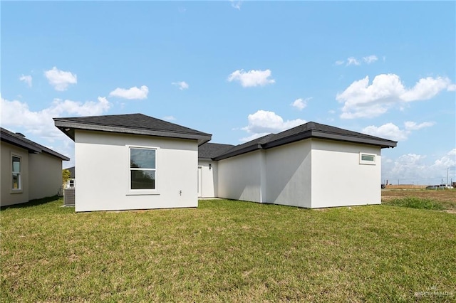 2012 Trinity St, Donna, TX 78537 - back of house with a lawn and stucco siding