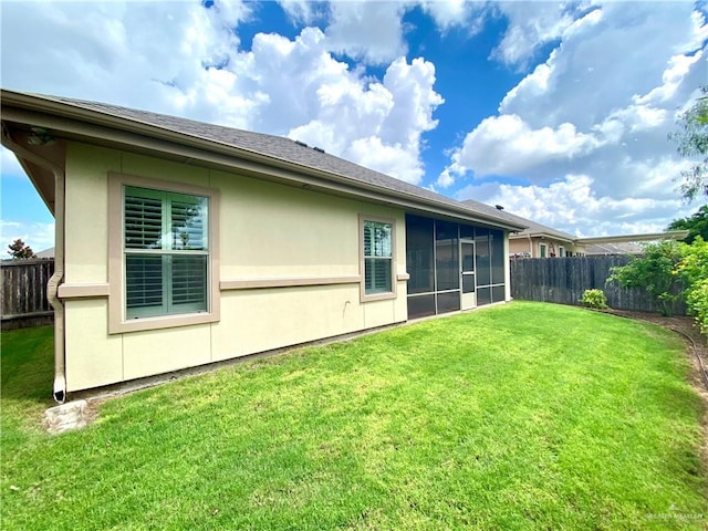 rear view of property featuring a lawn