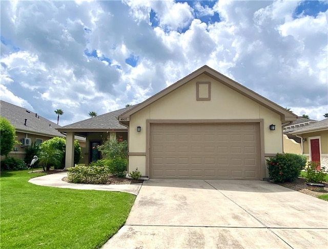 single story home with a front yard and a garage