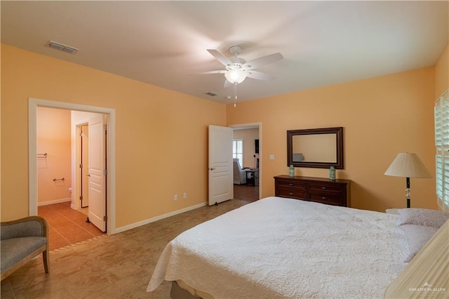 tiled bedroom featuring ensuite bathroom and ceiling fan