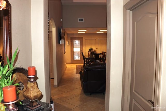 hall featuring arched walkways, visible vents, and tile patterned floors