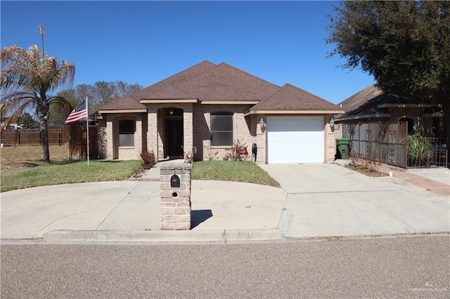 ranch-style home with an attached garage, brick siding, fence, driveway, and a front lawn