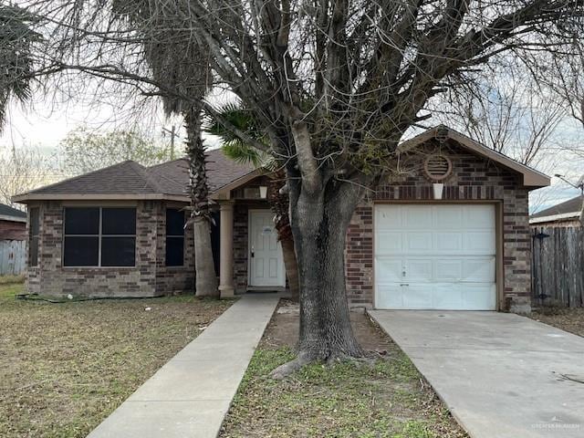 ranch-style home with a garage and a front yard