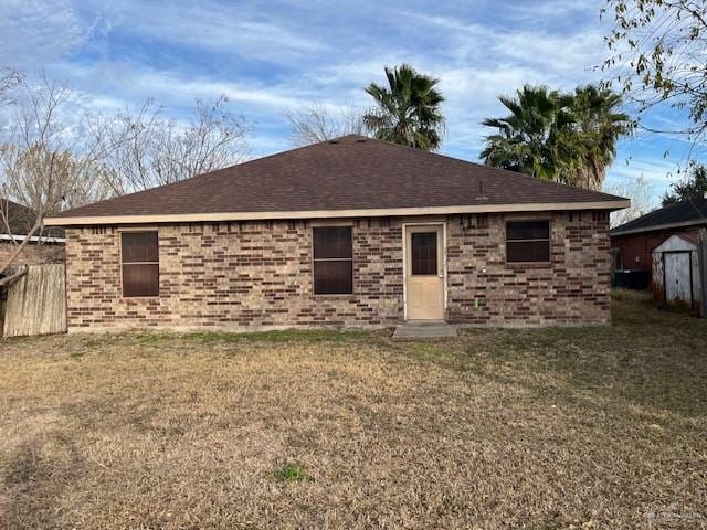 back of house featuring a lawn