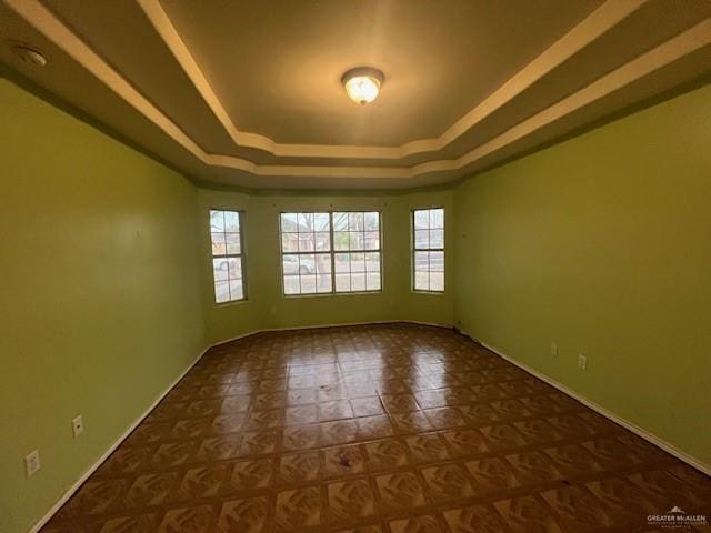 empty room featuring a tray ceiling