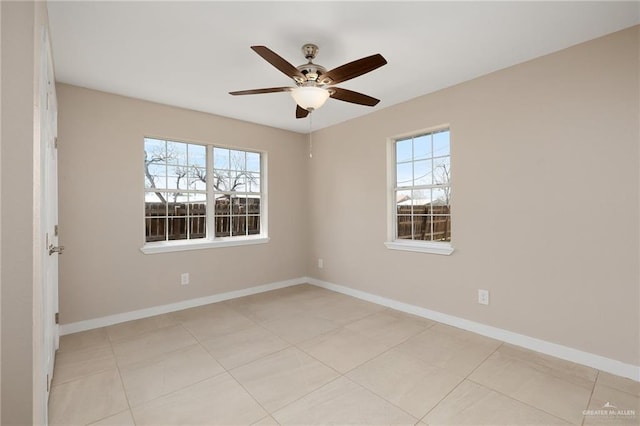 empty room featuring ceiling fan and light tile patterned floors