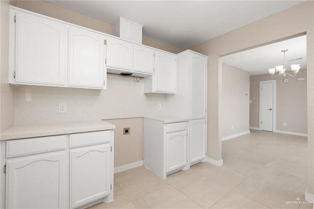 kitchen featuring white cabinetry, hanging light fixtures, and a notable chandelier